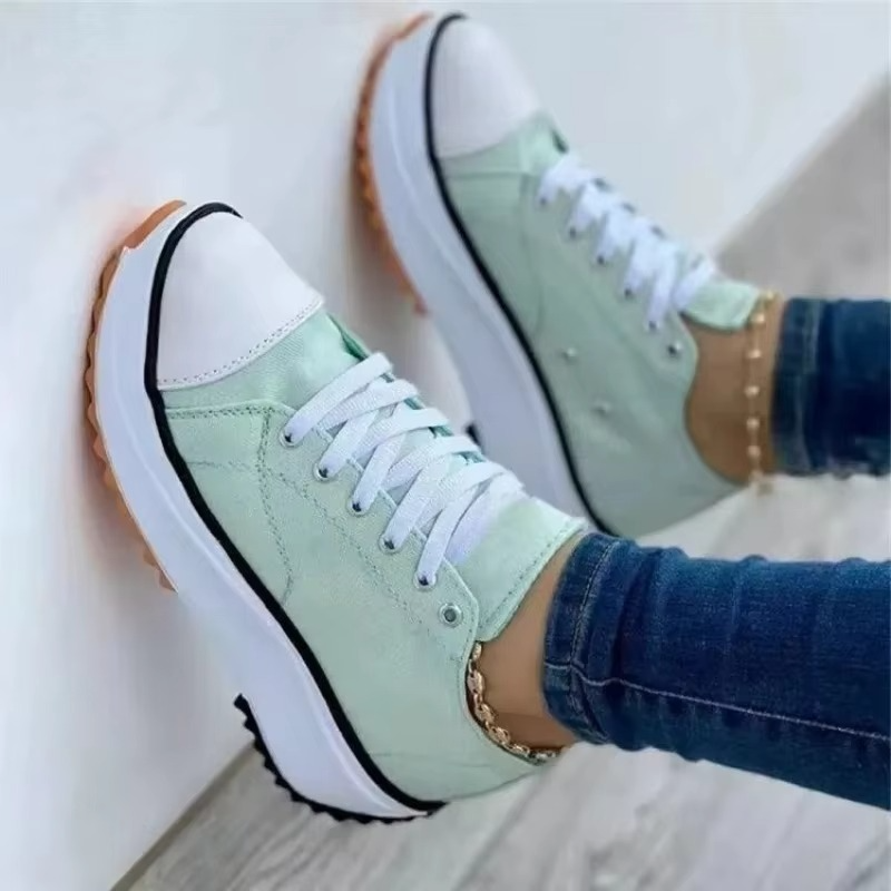 Women's white canvas platform sneakers with breathable upper and lightweight comfort sole, casual style