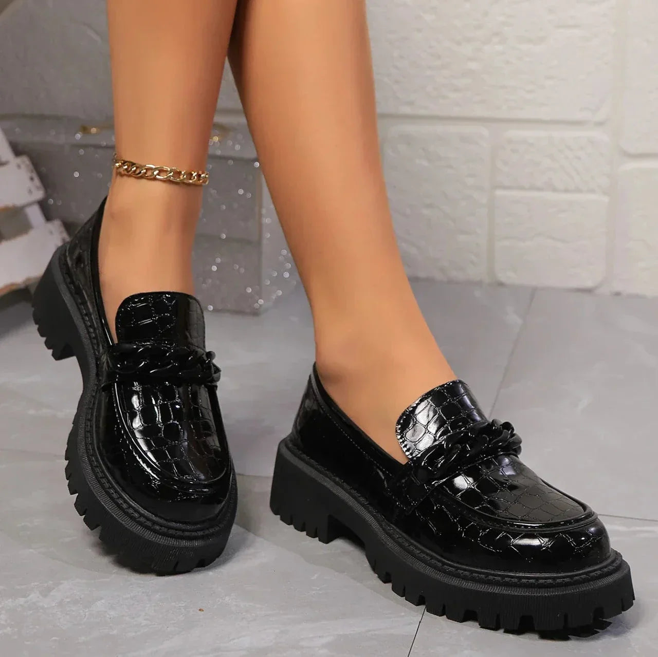 Black vegan leather platform loafers with crocodile embossing and satin-gloss finish for women