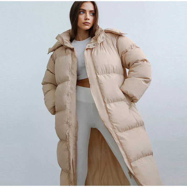 Women's long hooded puffer coat in neutral tone, full-length streamlined silhouette for cold weather
