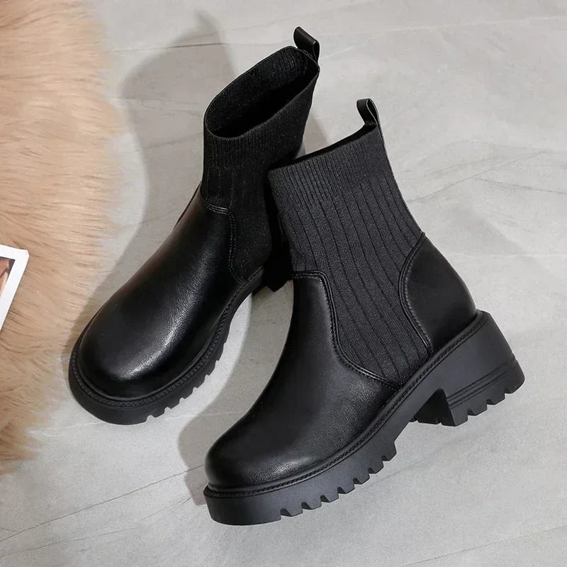 Women's black split-knit platform boots with faux leather accents and rubberized heel