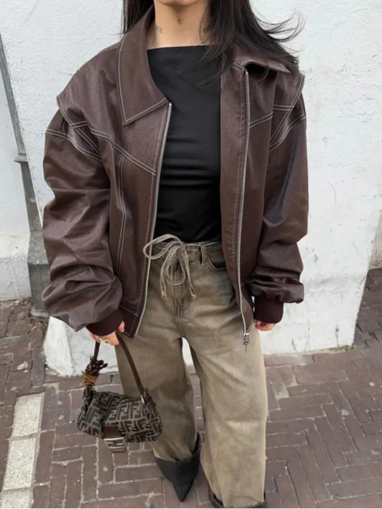 Women's black oversized leather bomber jacket relaxed fit with front zip closure bold street style
