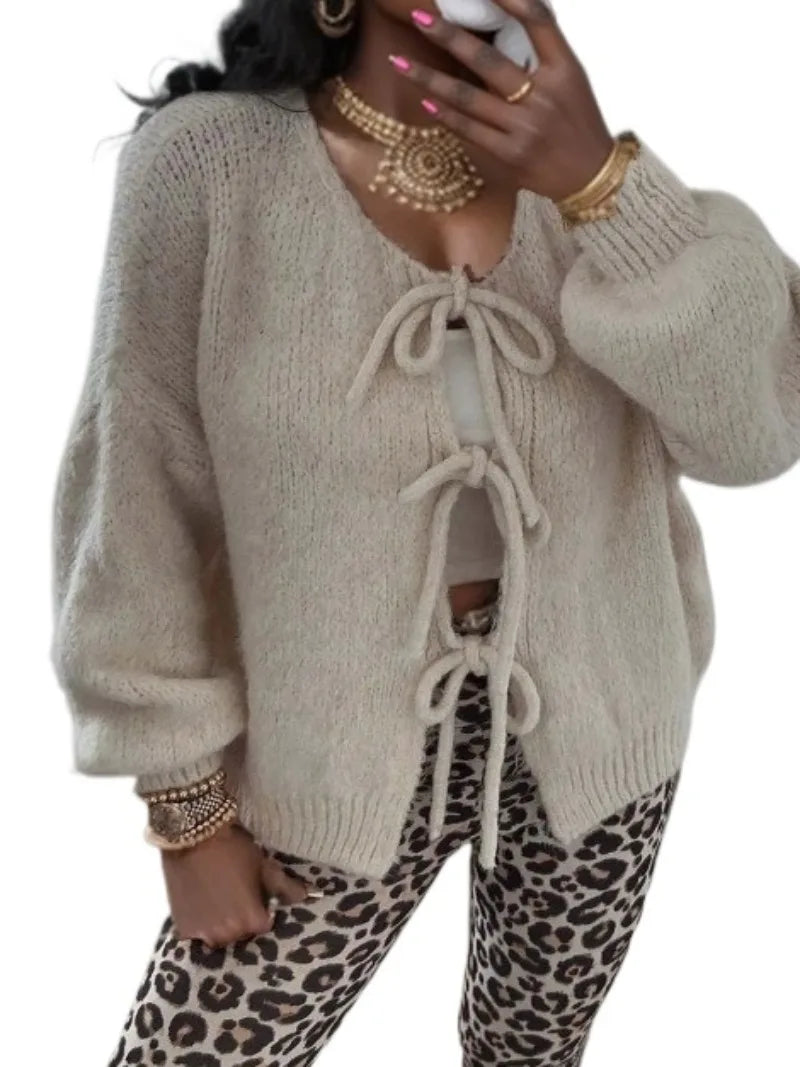 Women's chunky knit oversized cardigan with cozy knotted front detail and wide sleeves for winter