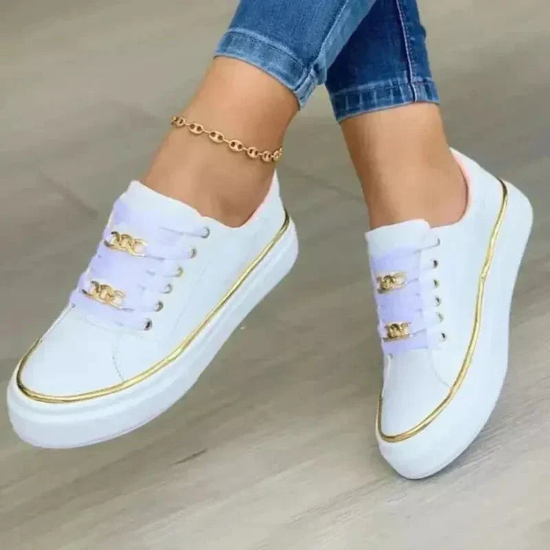 Women's white minimalist sneakers with metallic chain lace detail and cushioned sole for everyday wear