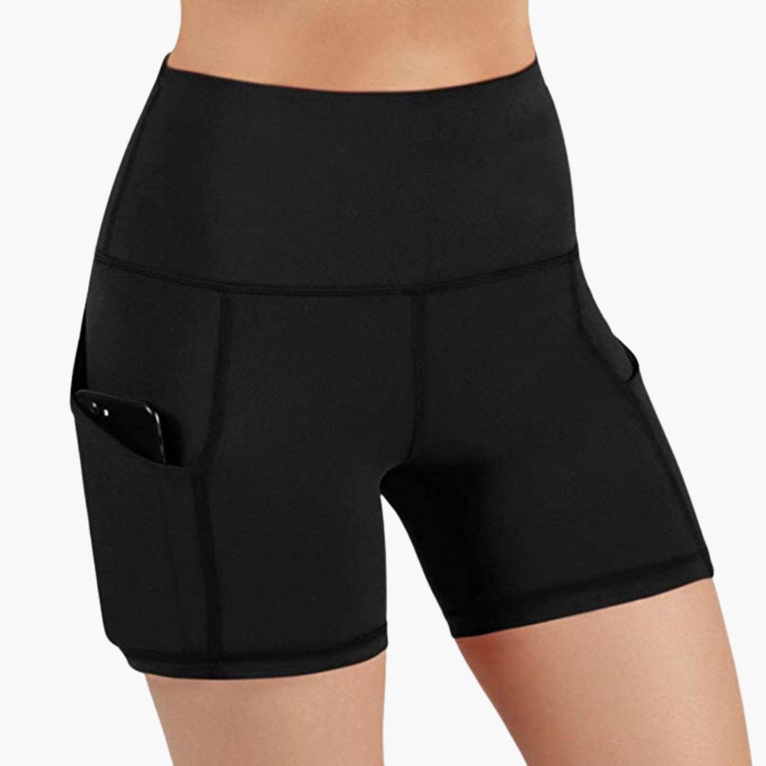 High waisted women's sports shorts with side pockets, breathable active wear in neutral tone