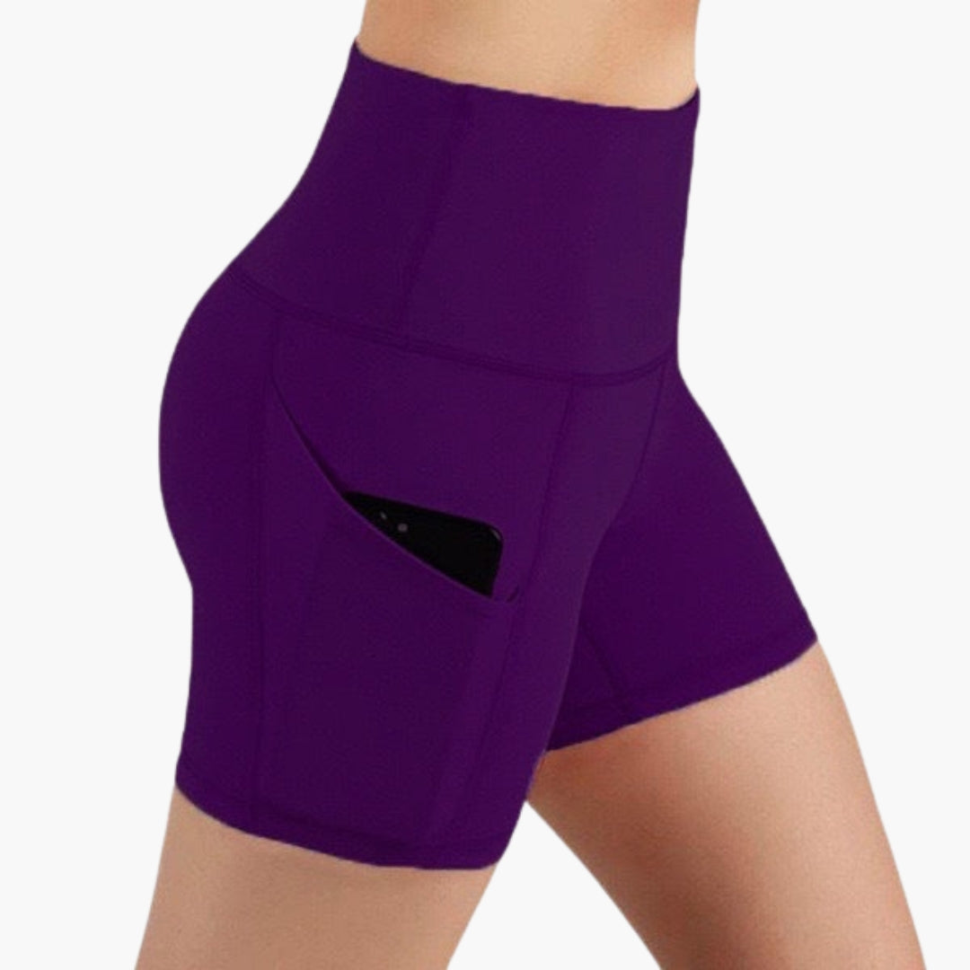 High waisted women's sports shorts with side pockets, breathable activewear in solid color