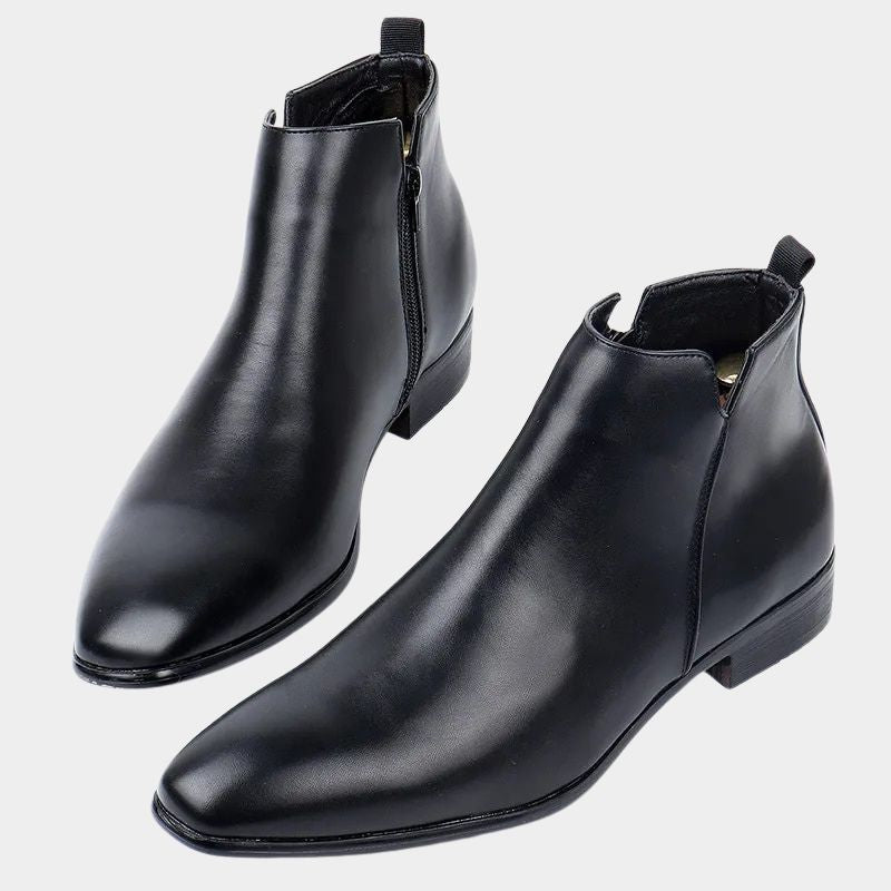 Men's black sleek ankle boots with side-zip closure, tapered silhouette, and low heel for modern wear