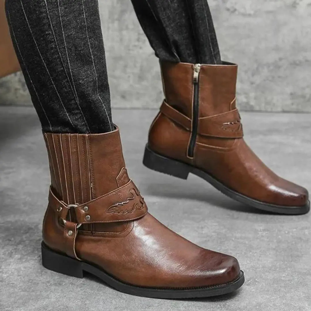 Brown faux leather Western boots with rugged strap detail, vintage-inspired streetwear silhouette