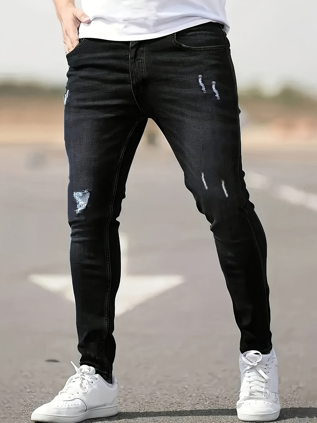 Men's slim fit stretch denim jeans with ripped details, tapered ankle cut for edgy streetwear style