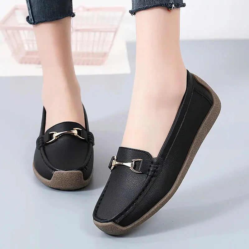 Women's slip-on moccasin flats in neutral tone with soft faux leather upper and flexible sole