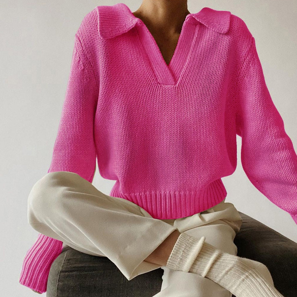 Women's loose fit knit sweater in neutral tones with bold lapel and irregular design detail