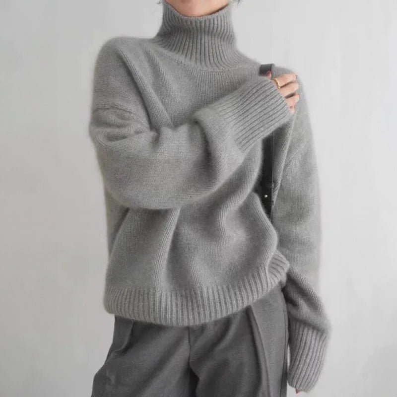 Women's relaxed-fit turtleneck knit pullover in soft neutral tones, cozy oversized silhouette