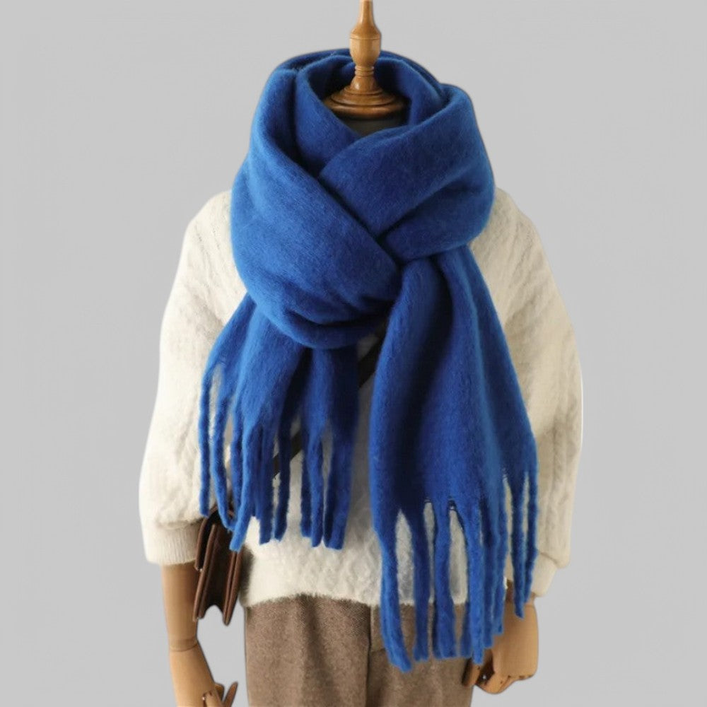 Women's oversized plush winter scarf in neutral tones with long fringe ends for elegant cold-weather style