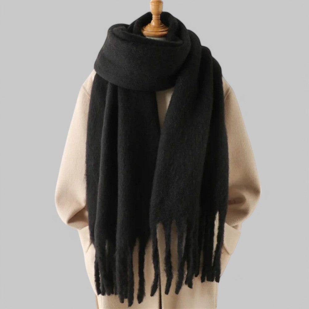 Women's oversized plush winter scarf in neutral tones with long fringed ends for elevated cold-weather style