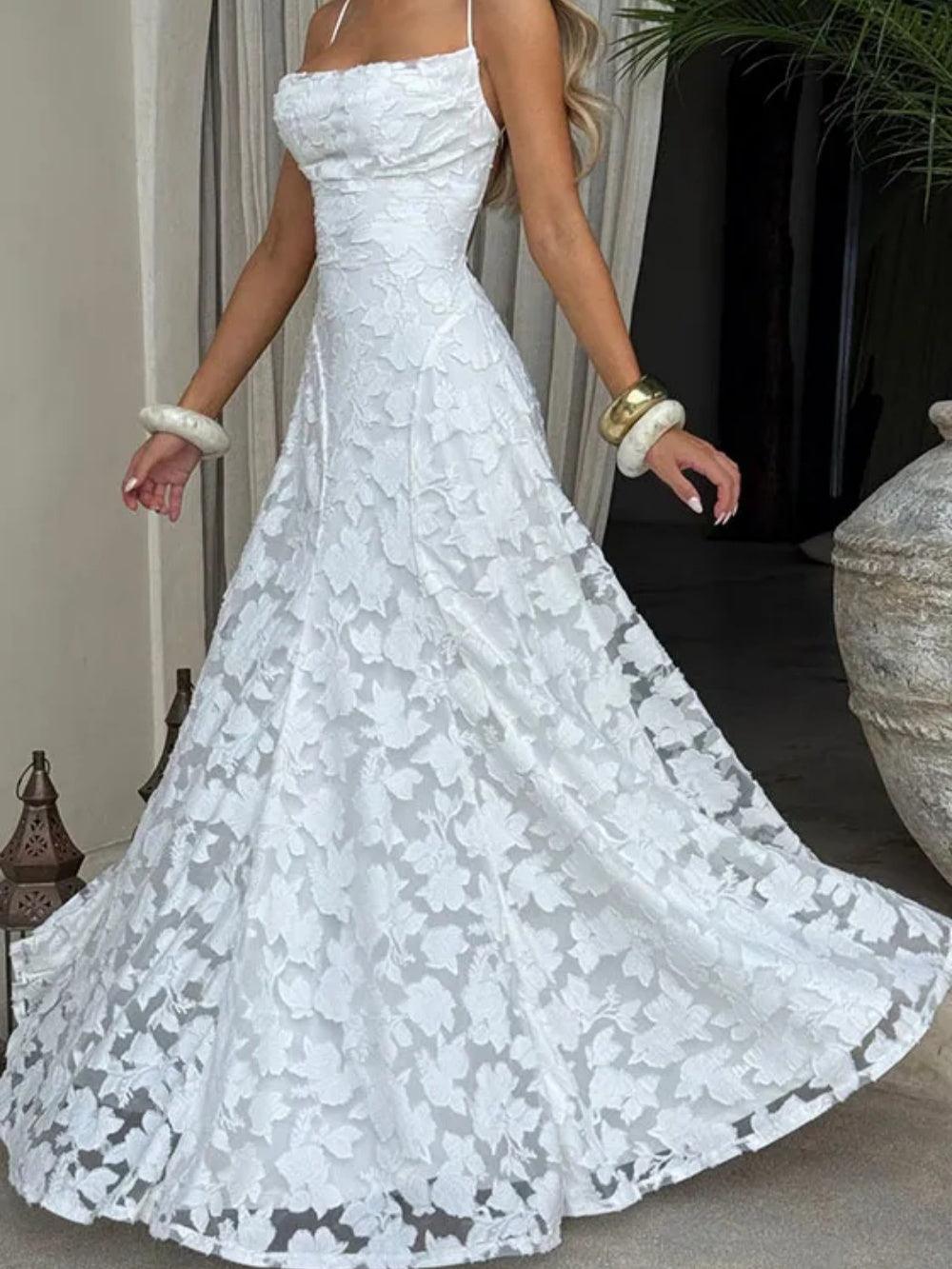 White lace spaghetti strap long dress with elegant flowing silhouette and delicate floral lace detail