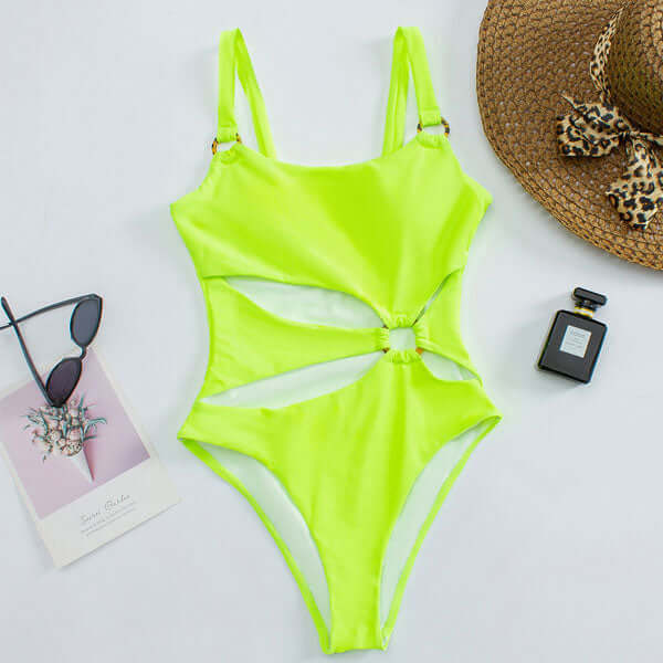 Black cutout swimsuit with metallic ring details, open-front design, and straight-neck silhouette