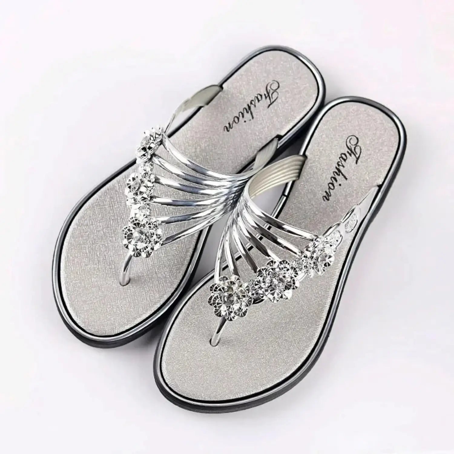 Women's strappy flat sandals with sparkling floral embellishments, elegant summer footwear