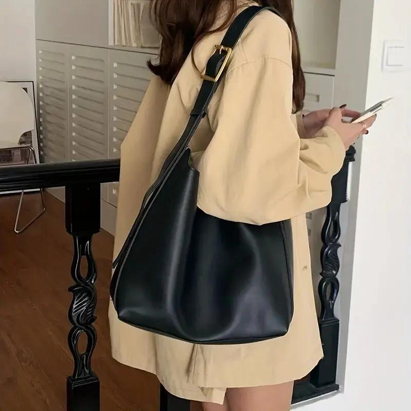Structured vegan leather women's shoulder bag with wide adjustable strap, polished smooth finish