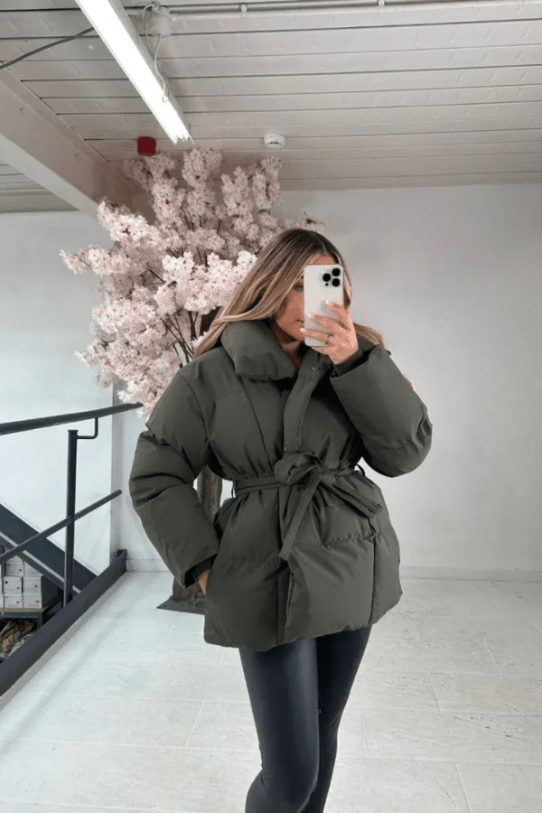 Women's belted puffer jacket with high collar, cozy padding, flattering silhouette for winter
