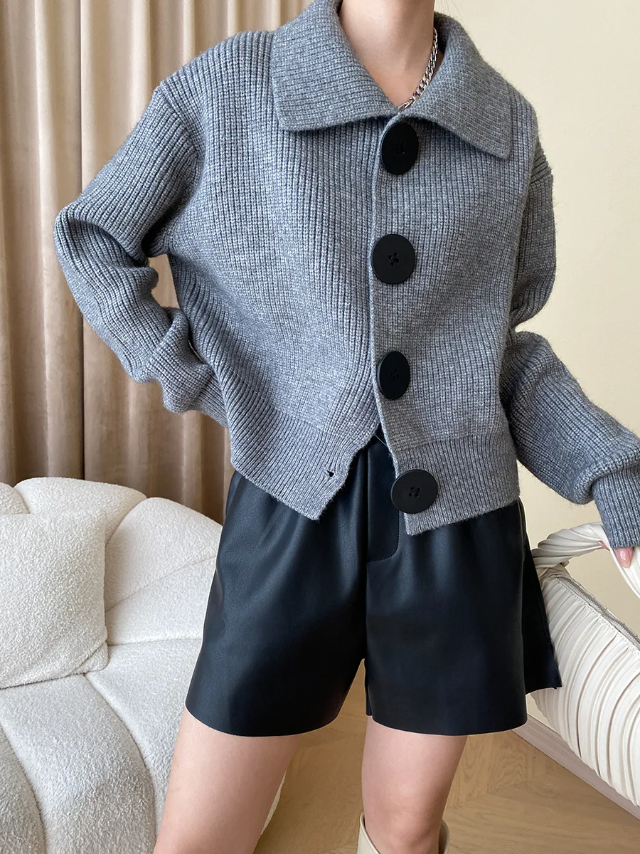 Women's oversized-button cardigan in soft textured knit, relaxed fit with bold black button-down closure