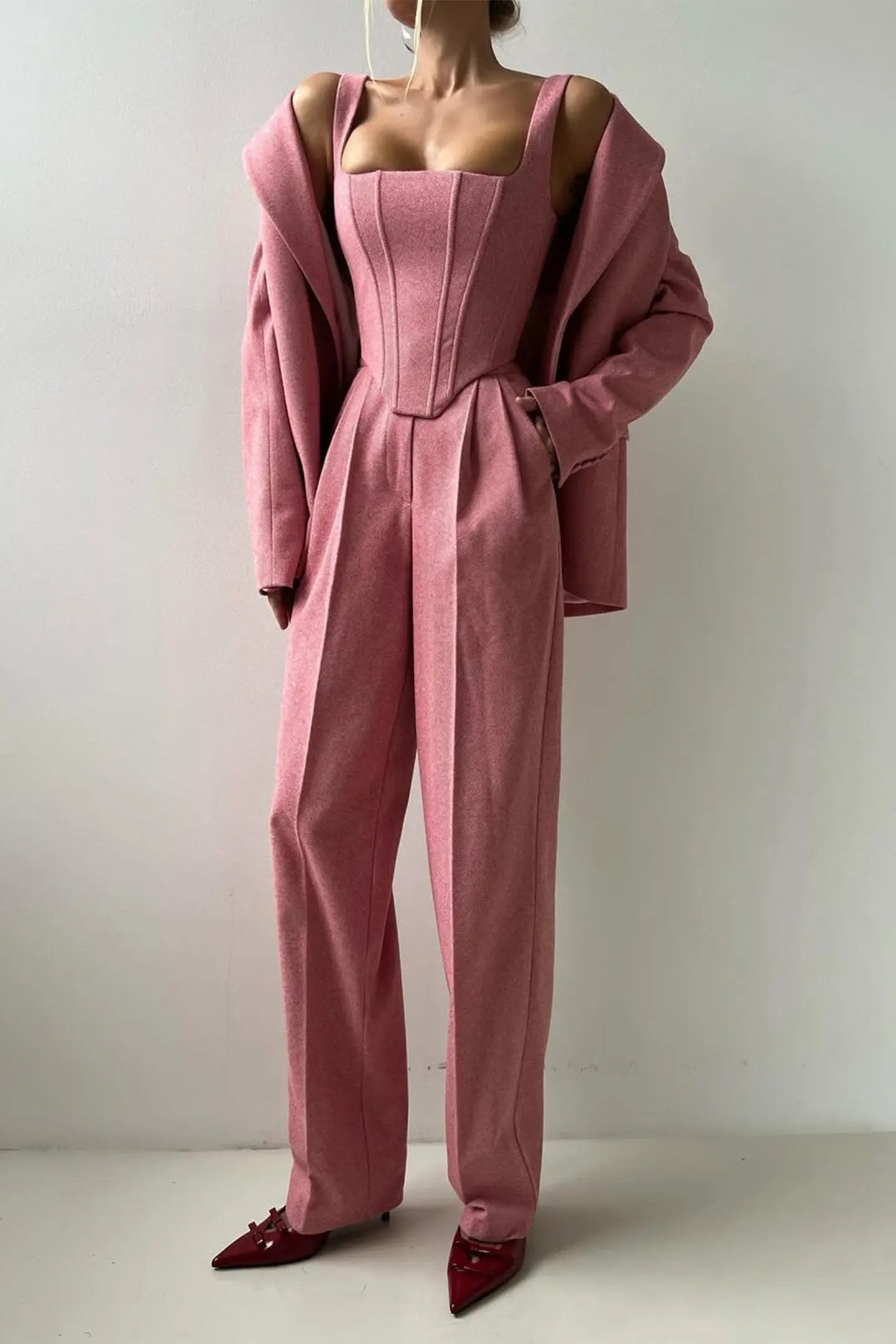 Women's tailored three-piece pant suit set with bustier top and wide-leg trousers for boardroom elegance