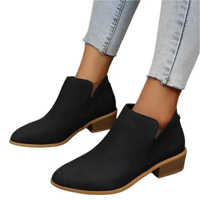 Women's black tapered low heel boots with perforated detailing and sleek silhouette
