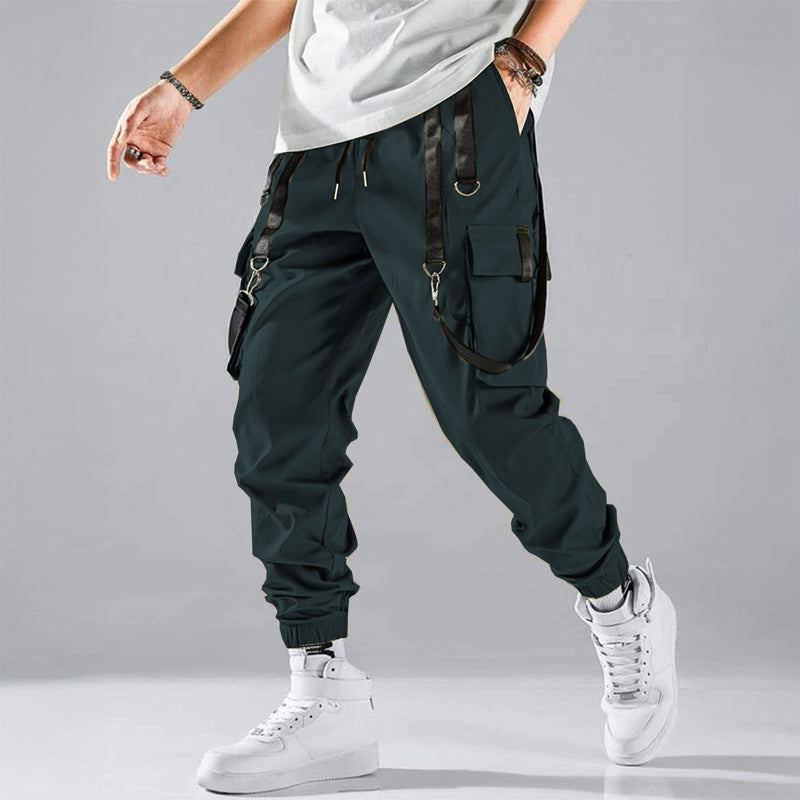 Black cargo trousers with tactical pockets, harness details, and adjustable buckle straps for streetwear