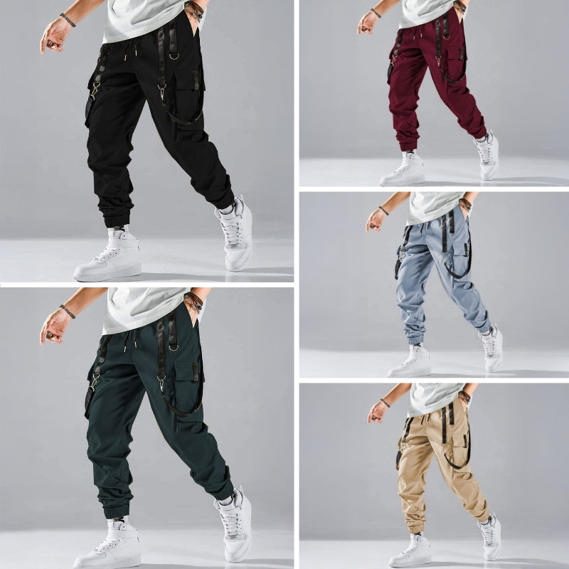 Black cargo trousers with tactical pockets, harness details, and adjustable buckle straps for streetwear
