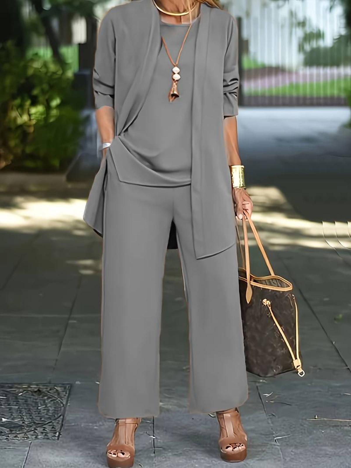Women's three-piece relaxed outfit set in coordinated tones with wide-leg pants and flowing top