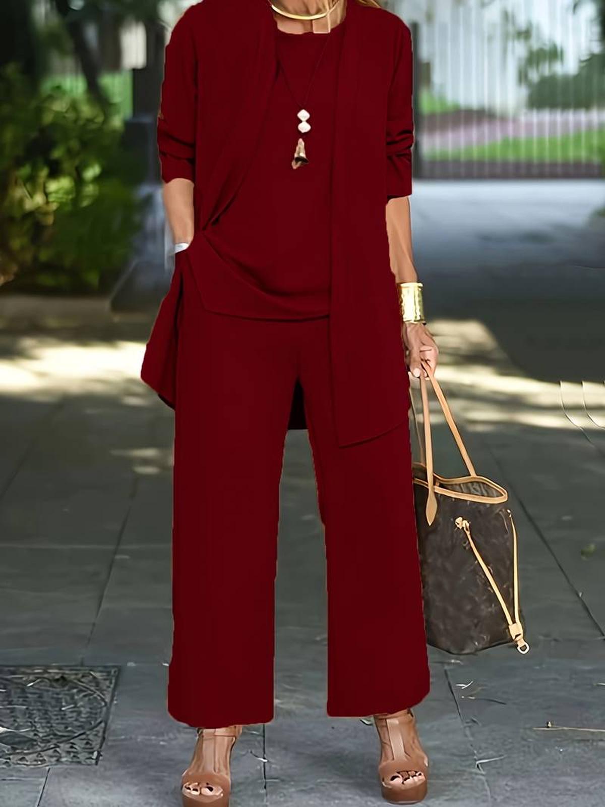 Women's three-piece relaxed outfit set in neutral tones featuring wide-leg pants and flowing layers