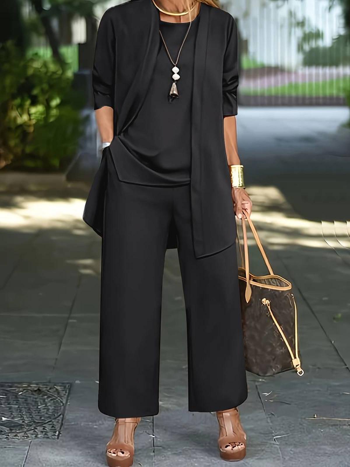 Women's three-piece relaxed outfit set in neutral tones with wide-leg pants and flowing layered top