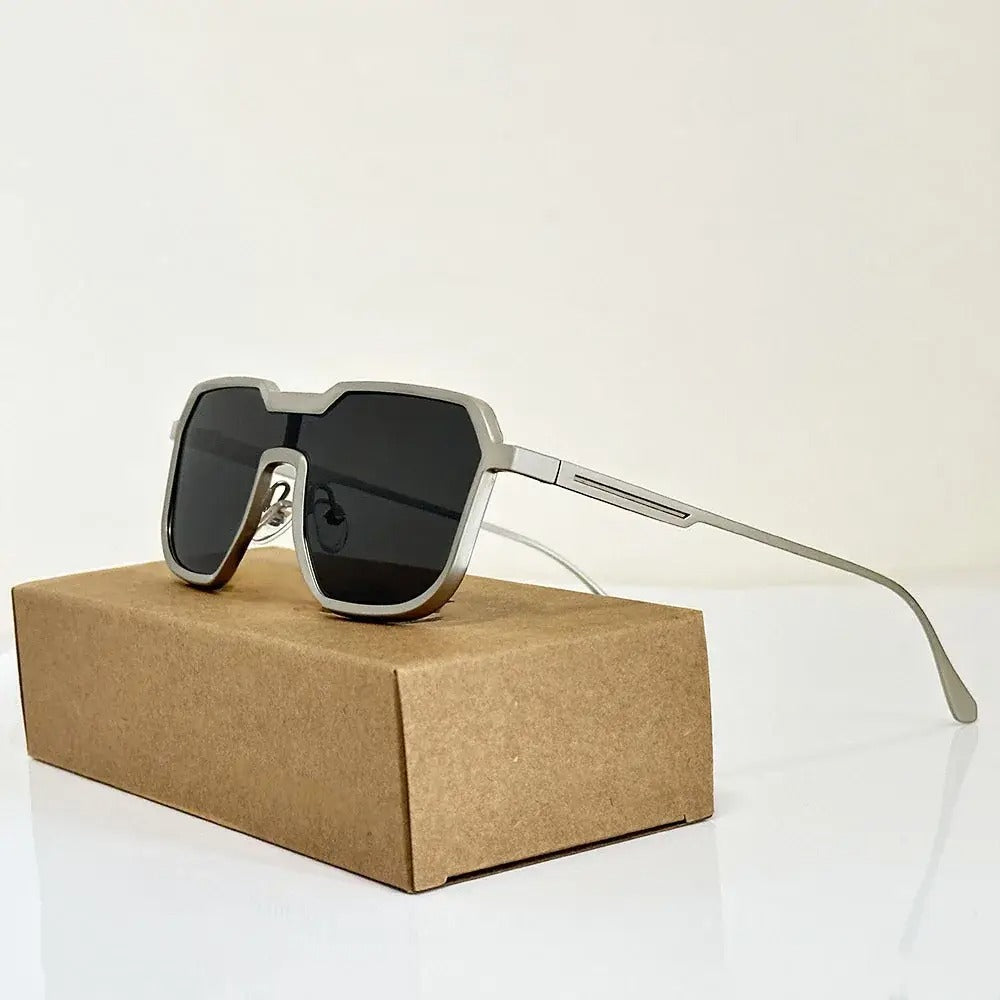Black oversized shield frame visor sunglasses futuristic angular cut-out lenses urban streetwear UV protection