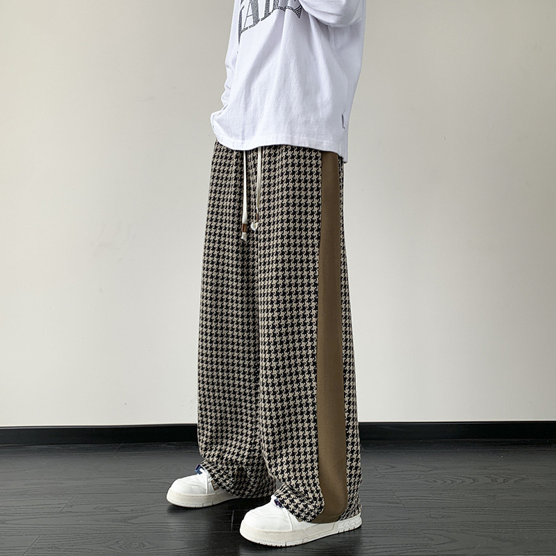 Black wide-leg grid print streetwear pants with contrast side stripes relaxed fit