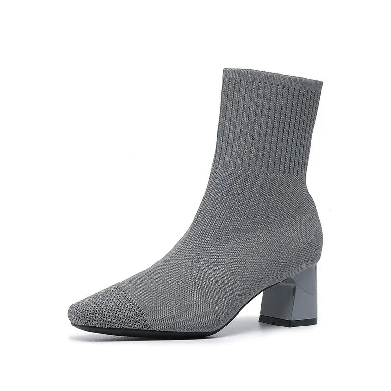 Women's stretchy knit sock boots mid heel ankle booties in neutral toned seamless silhouette