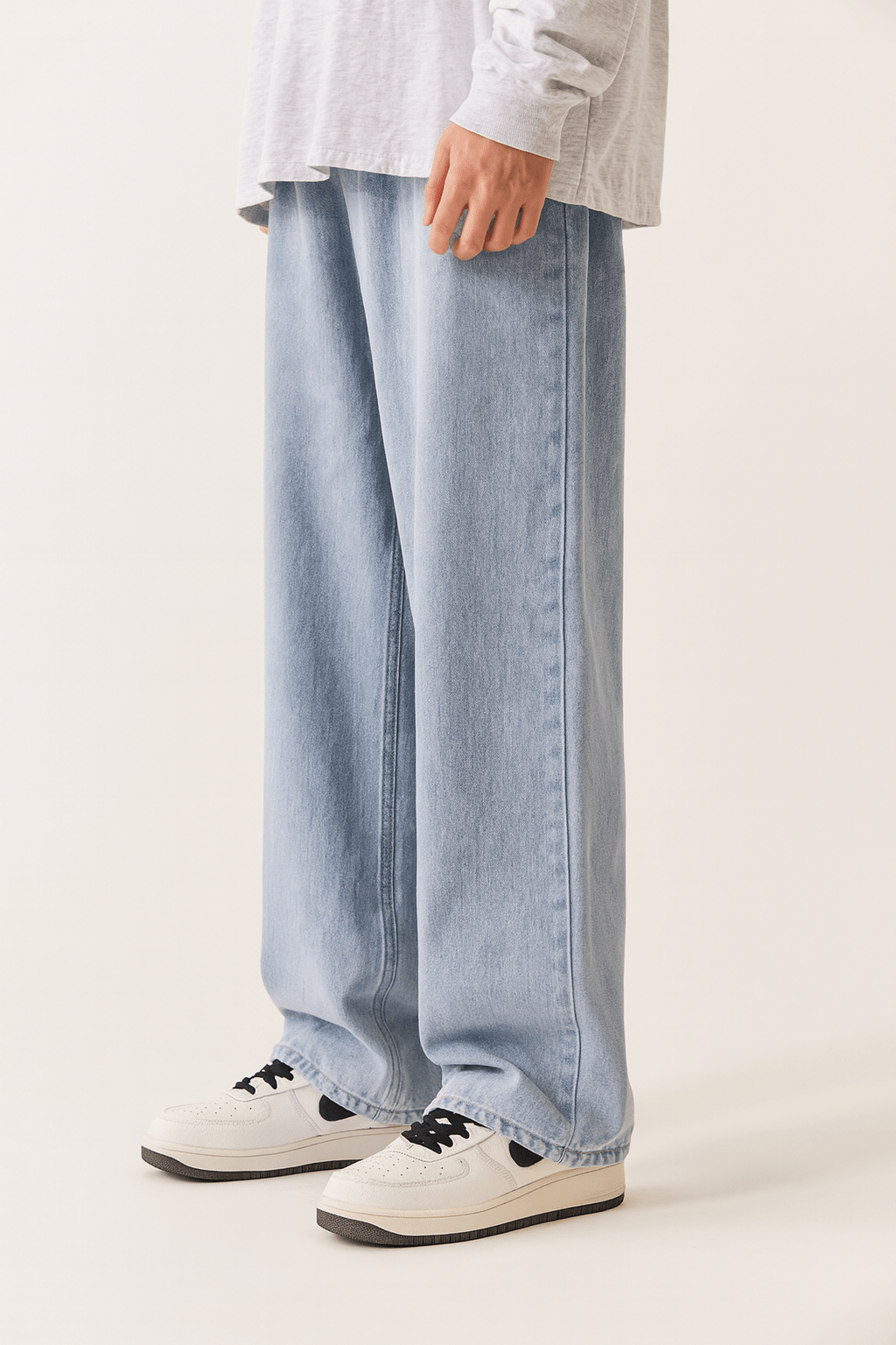 Light blue ultra wide leg jeans with subtle washed effect, relaxed retro streetwear cut for creative style