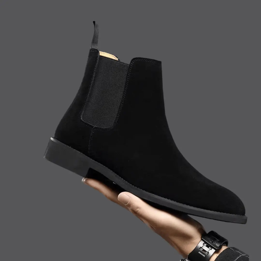 Olive green suede Chelsea boots with elastic side panels and sleek slip-on silhouette