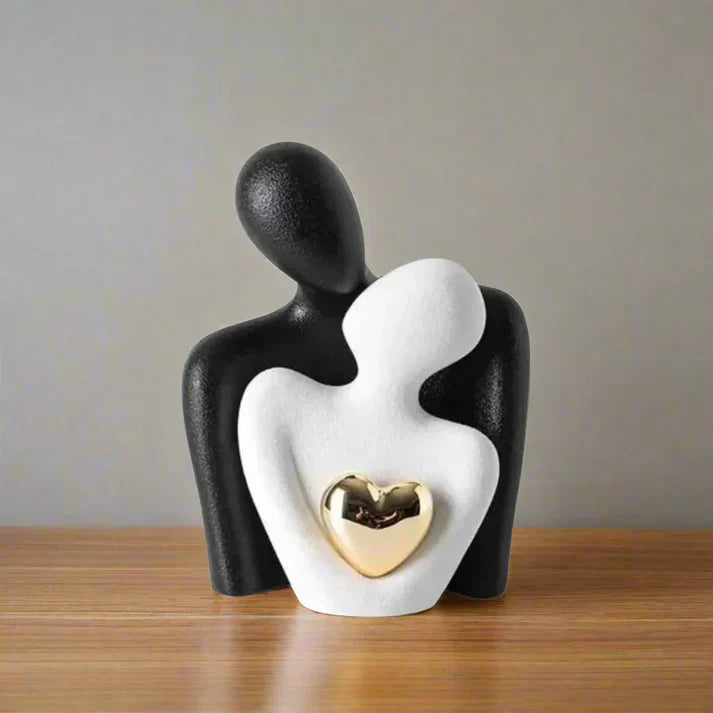 Matte black ceramic abstract sculpture with polished golden heart accent, modern home decor centerpiece