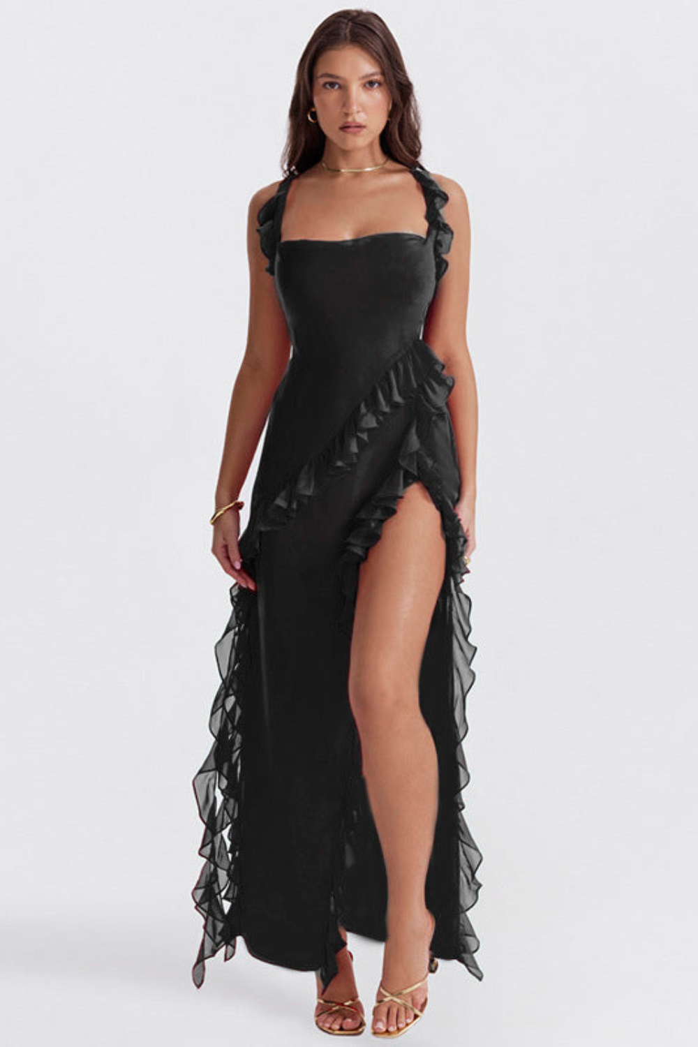 Melantha black ruffled maxi dress with adjustable straps, high slit, and asymmetrical ruffle detail