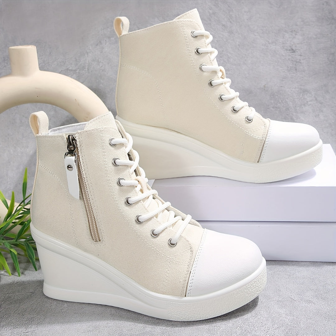 Women's white canvas wedge sneaker with hidden heel lift and breathable side zipper closure