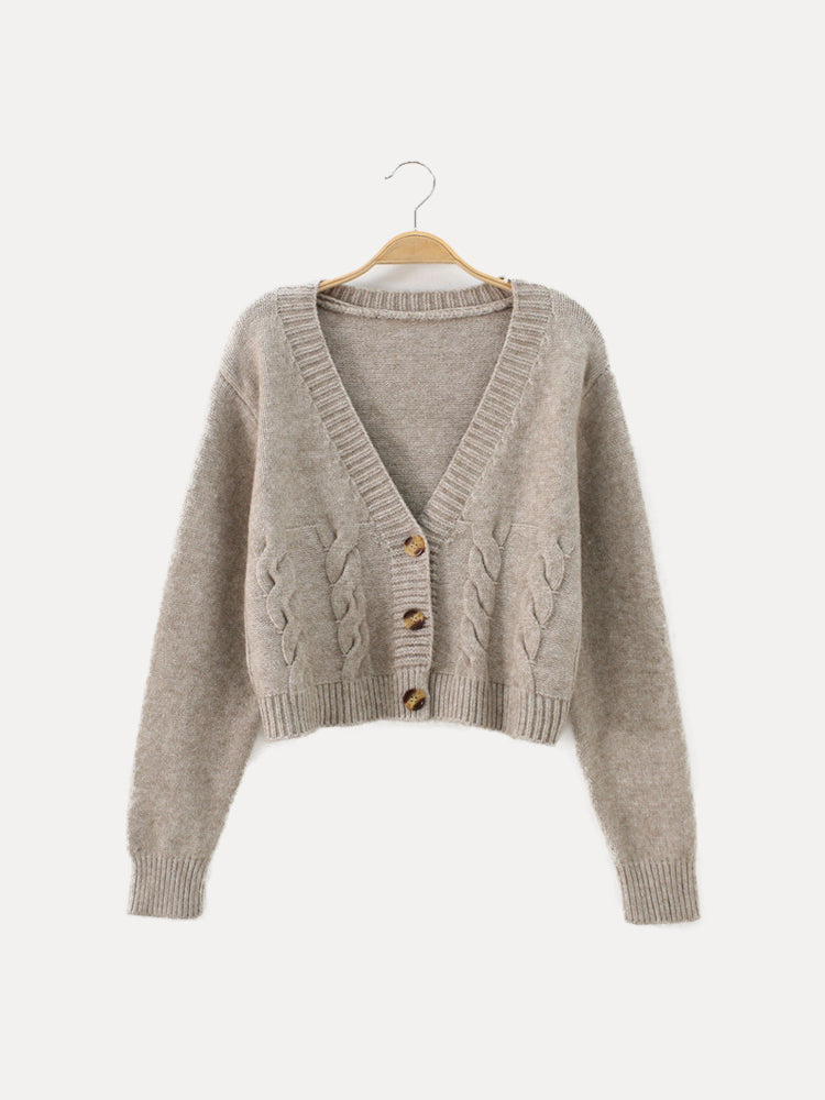 Women's cream cable knit crop sweater with V-neck button placket, cozy texture, waist-length silhouette