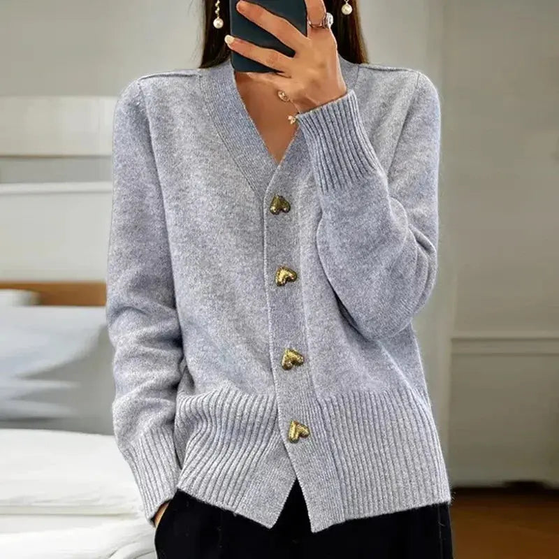 Women's cozy V-neck cardigan sweater, versatile layering piece with distinctive button details