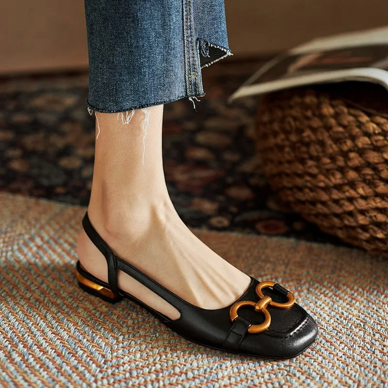 Nude sculpted slingback flats with open-back design and bold gold chain accent for everyday chic