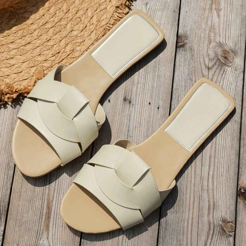 Women's sleek flat PU leather slip-on slippers in neutral tone with smooth refined finish