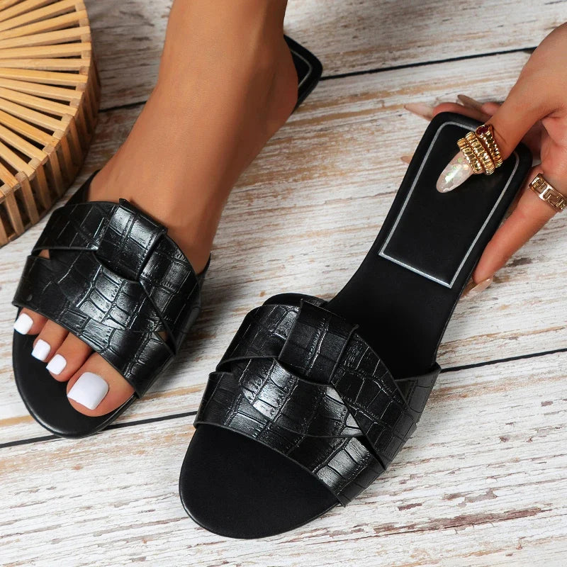 Women's flat PU leather slip-on slippers in sleek silhouette, polished finish for summer everyday wear