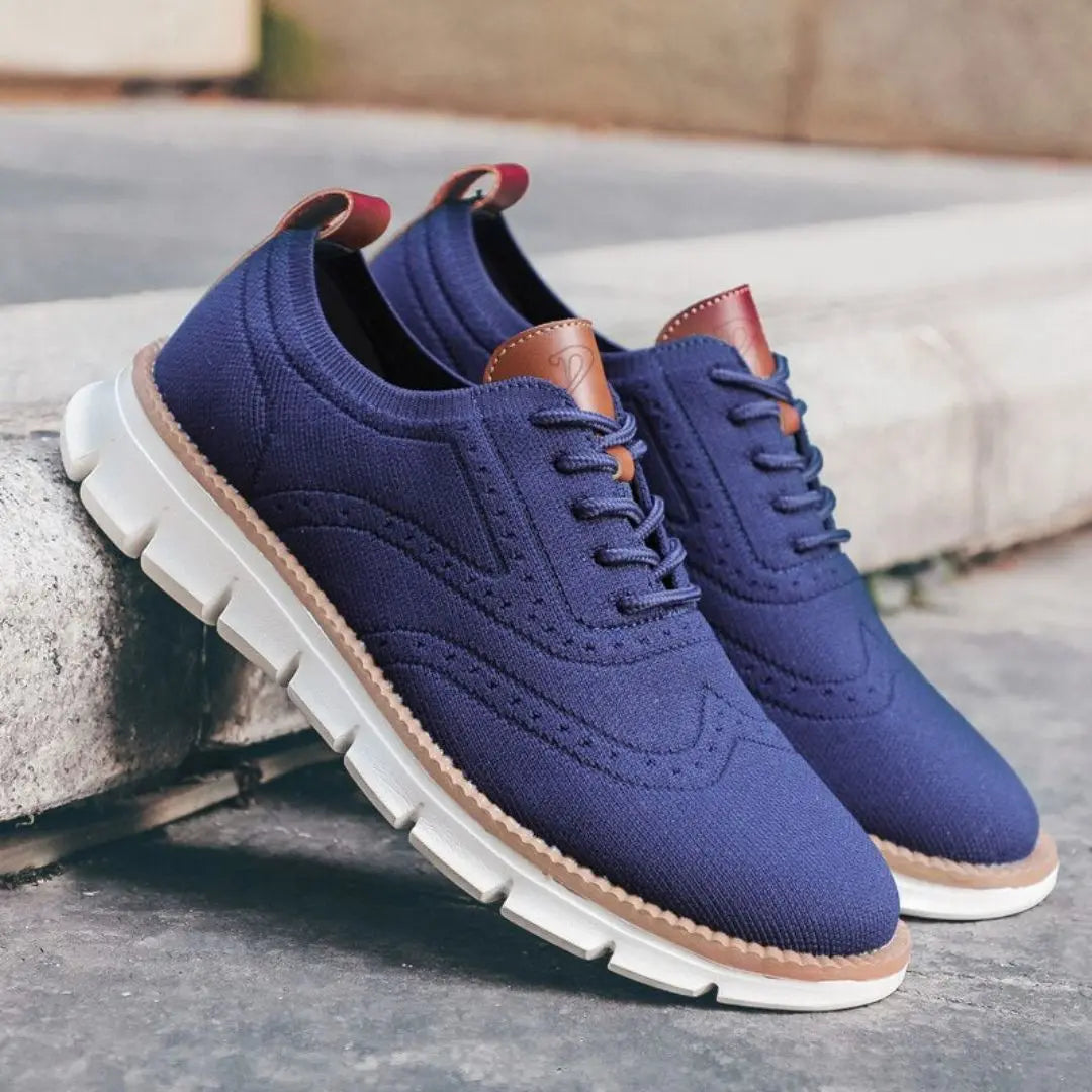 Men's white wingtip Oxford sneakers with cushioned sole and sleek urban business-casual design