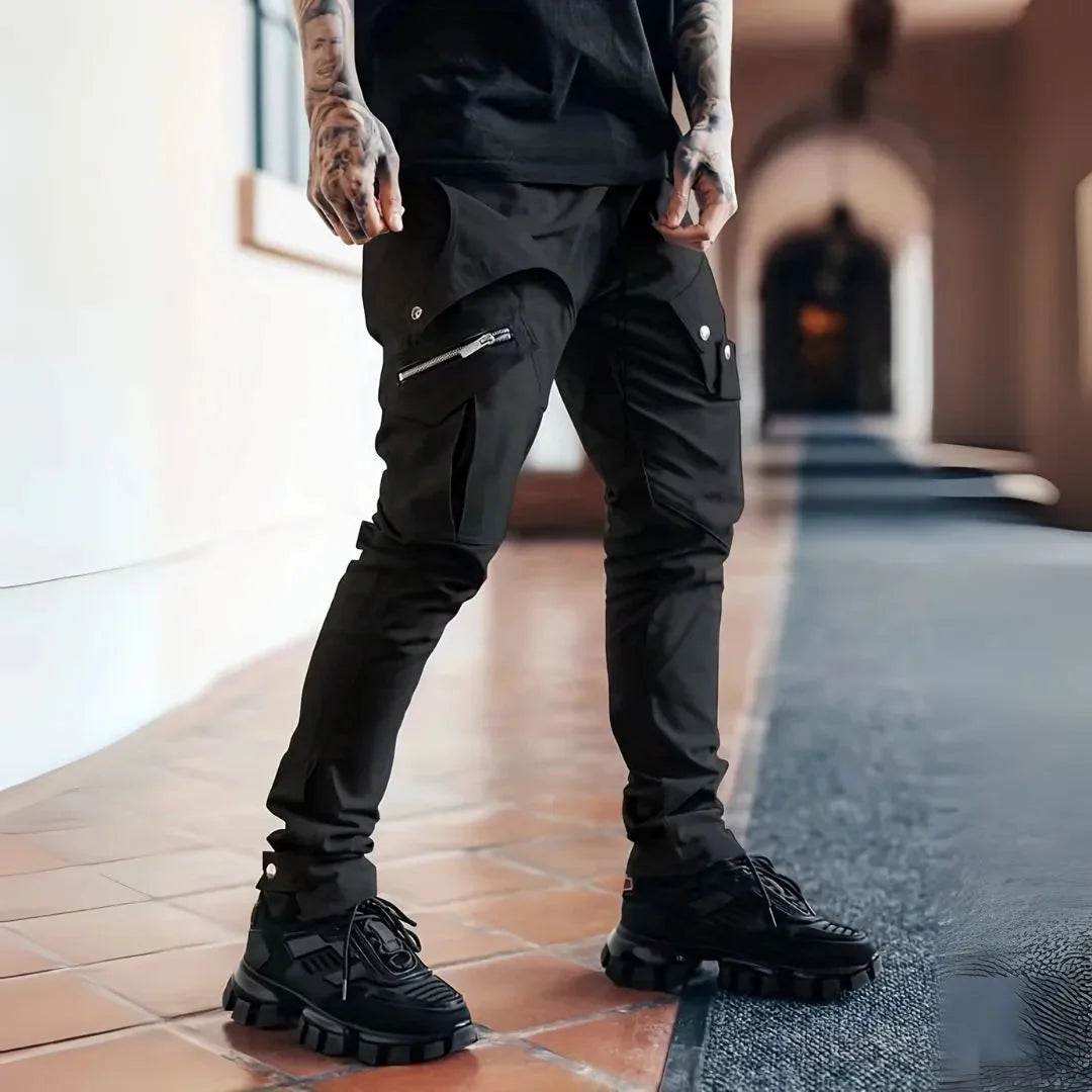 Black slim tapered cargo pants with exposed zips and multi-pocket streetwear design