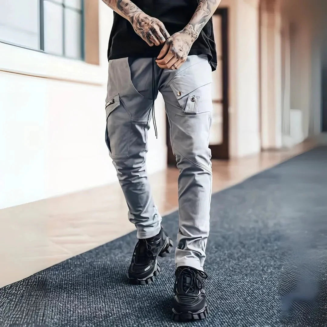 Black slim tapered cargo pants with multi-pocket design and exposed silver zips streetwear style