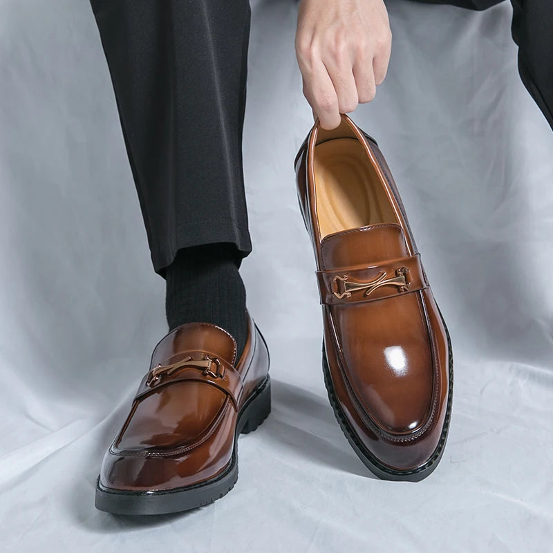 Men's black premium leather loafers with signature metal bit accent, polished executive slip-on style