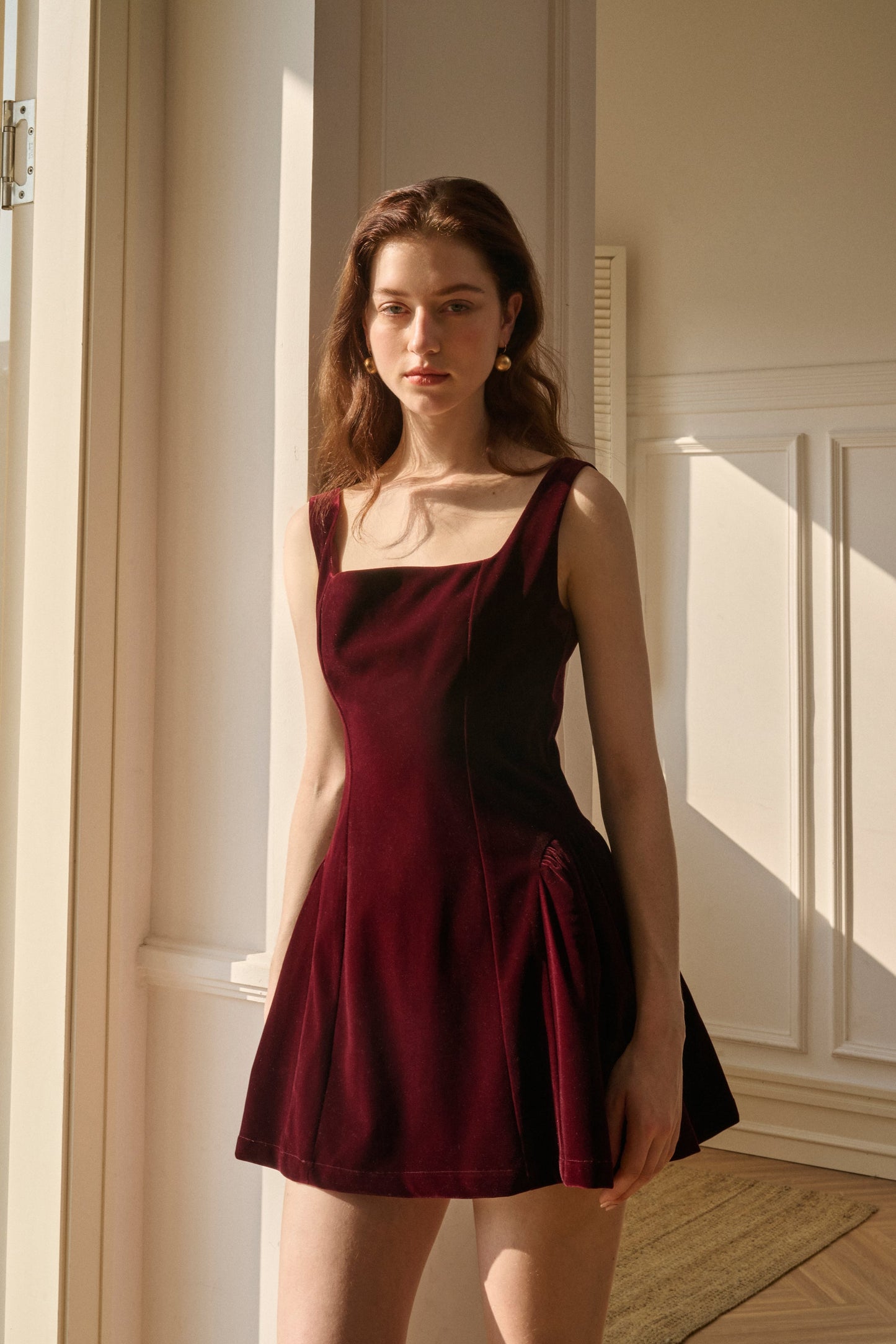 Burgundy velvet square neck mini dress with fitted bodice and structured silhouette for women