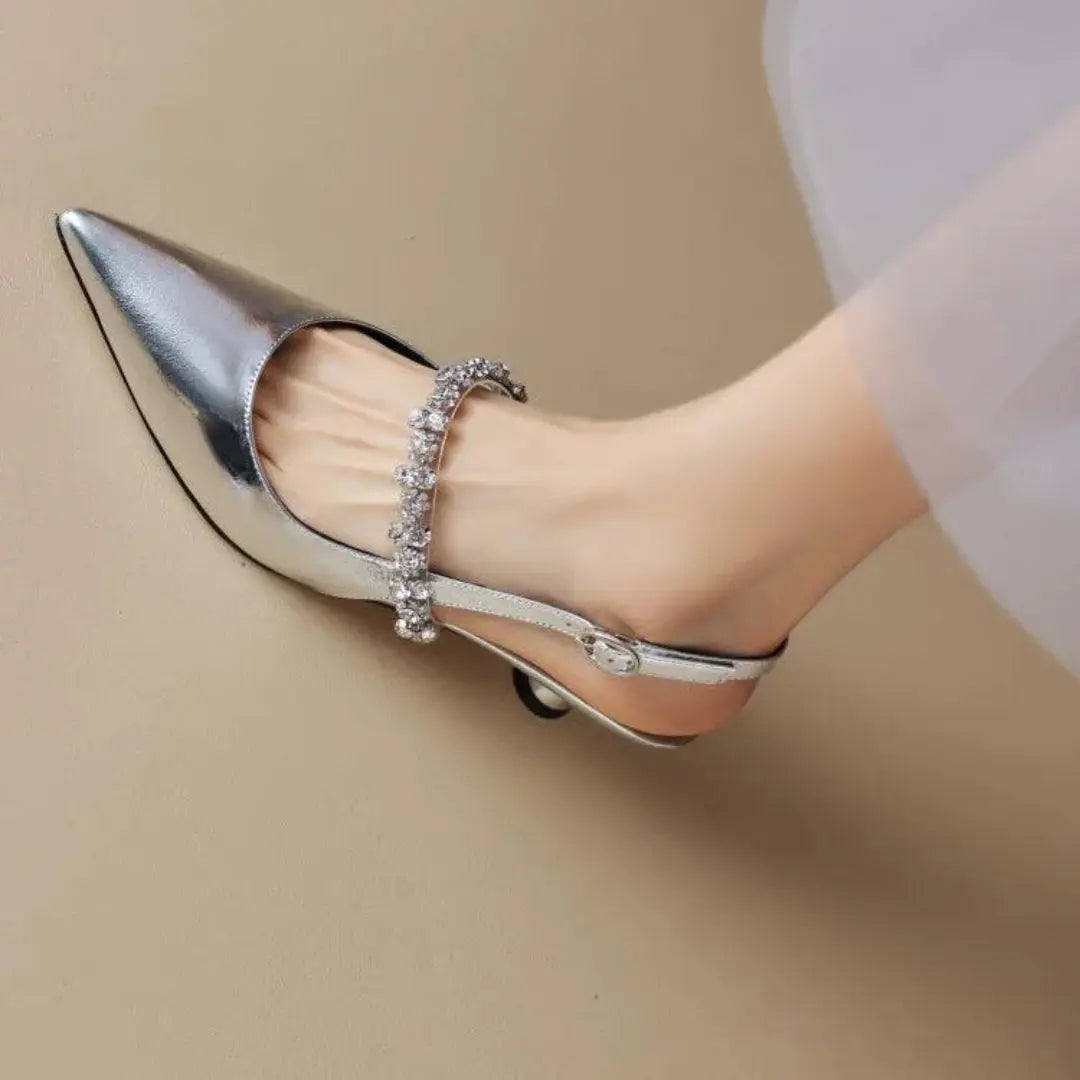 Silver rhinestone pointed toe slingback heels with sparkling embellished strap and mid-height heel