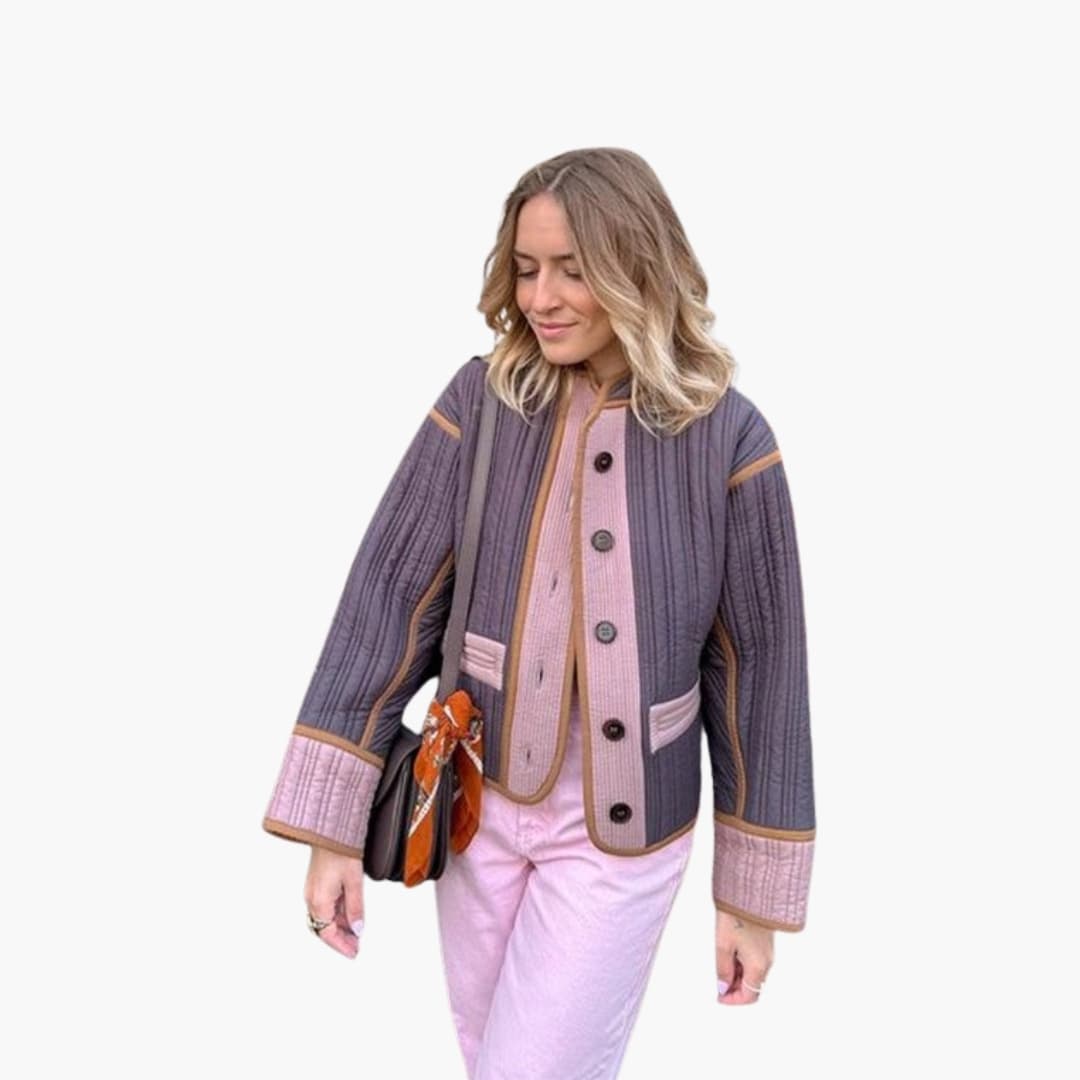 Women's quilted jacket with button closure, round neckline, contrast piping, and front pockets